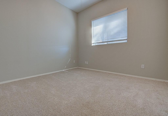 empty room featuring baseboards and carpet floors