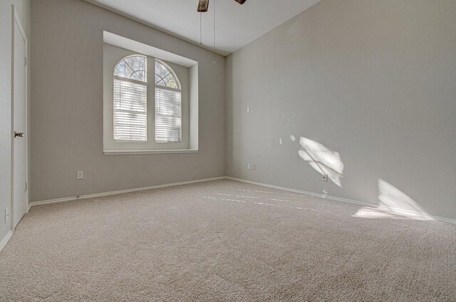 carpeted empty room with ceiling fan