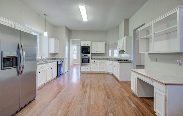 kitchen featuring decorative light fixtures, white cabinetry, light hardwood / wood-style floors, and black appliances