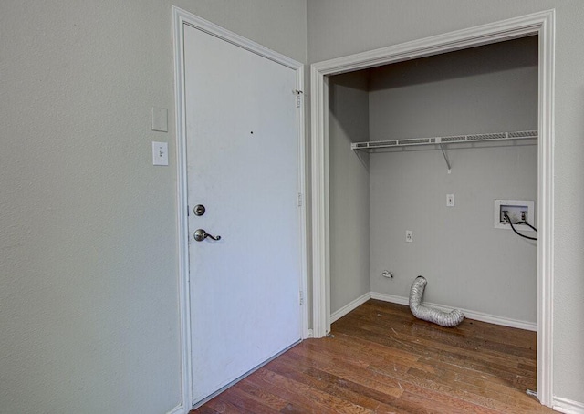 clothes washing area featuring laundry area, hookup for a washing machine, baseboards, and wood finished floors