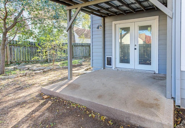 view of patio featuring french doors and fence