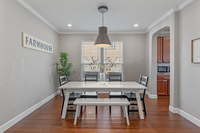 dining room featuring crown molding and dark wood-type flooring