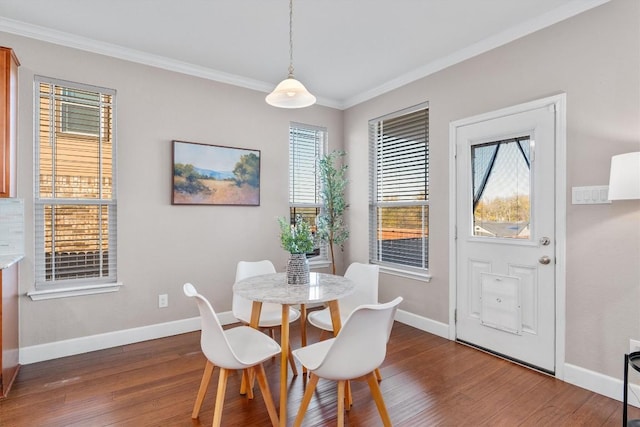 dining area featuring ornamental molding and dark wood-type flooring