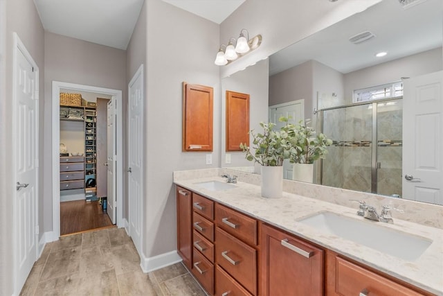 bathroom with vanity, hardwood / wood-style flooring, and walk in shower