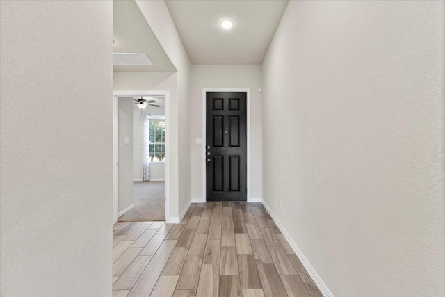 foyer featuring ceiling fan and light wood-type flooring