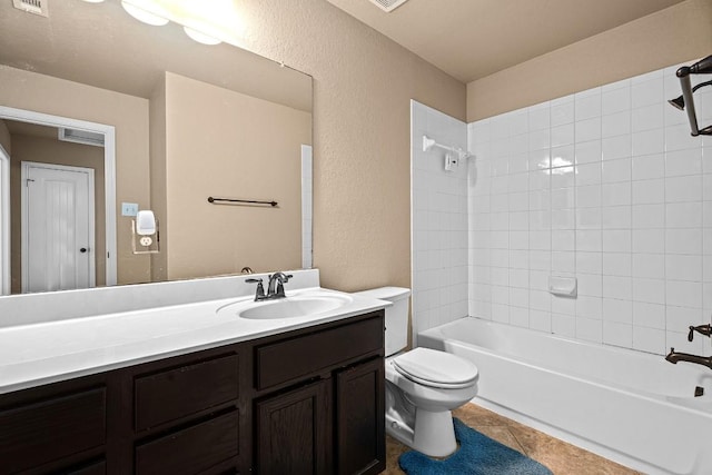 full bathroom featuring tile patterned floors, vanity, toilet, and tiled shower / bath