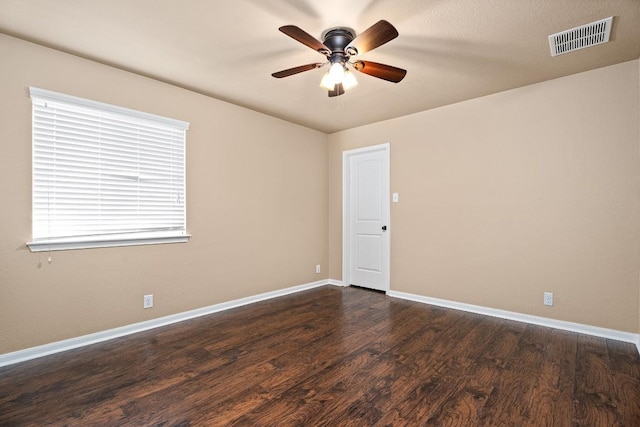 unfurnished room with ceiling fan and dark wood-type flooring