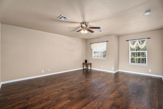 empty room featuring a textured ceiling, ceiling fan, and dark hardwood / wood-style floors