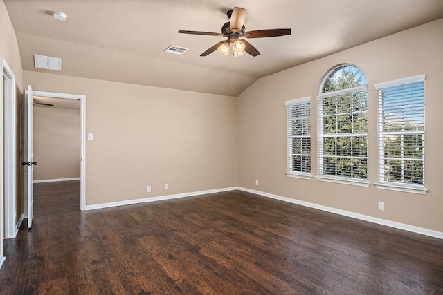 spare room with ceiling fan, dark wood-type flooring, and lofted ceiling