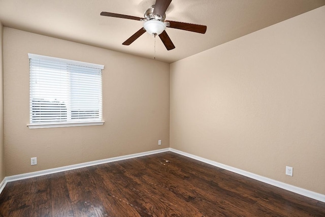 empty room with dark hardwood / wood-style floors and ceiling fan