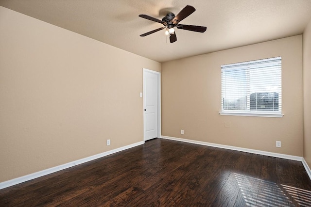 spare room with ceiling fan and dark wood-type flooring