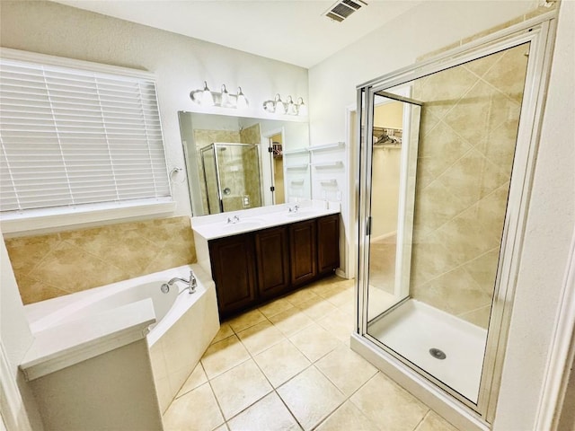 bathroom with tile patterned flooring, vanity, and plus walk in shower