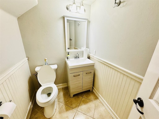 bathroom with tile patterned flooring, vanity, and toilet