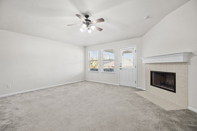 unfurnished living room with ceiling fan, a fireplace, and light carpet