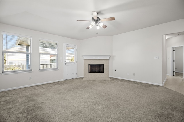 unfurnished living room featuring light carpet, a fireplace, and ceiling fan