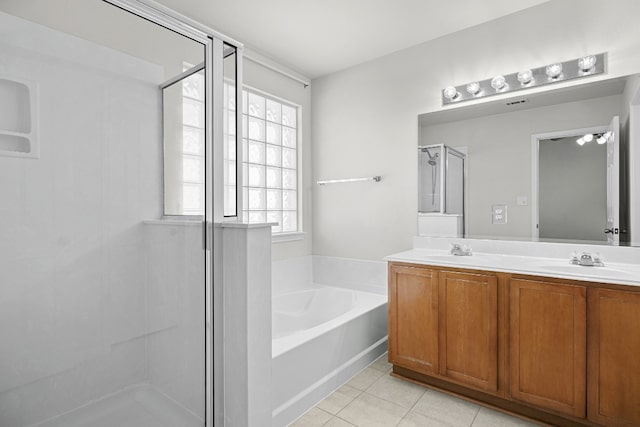 bathroom featuring tile patterned floors, vanity, and independent shower and bath