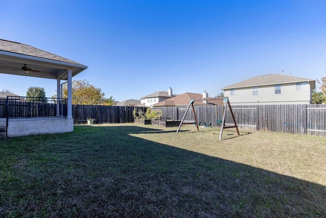 view of yard featuring a playground and ceiling fan