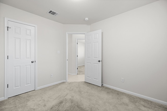 unfurnished bedroom featuring light carpet