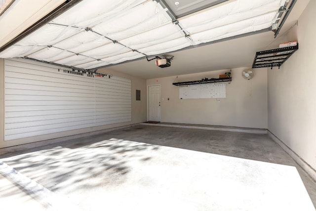 garage featuring electric panel and a garage door opener