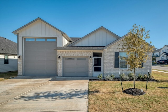 view of front of property with a garage and a front lawn