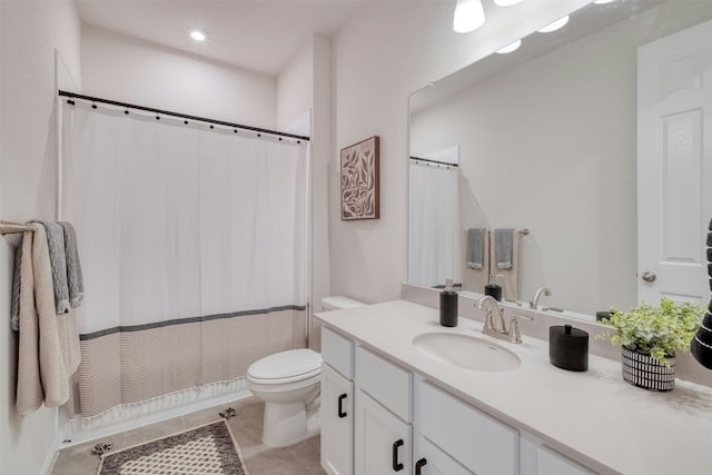 bathroom featuring tile patterned floors, vanity, and toilet