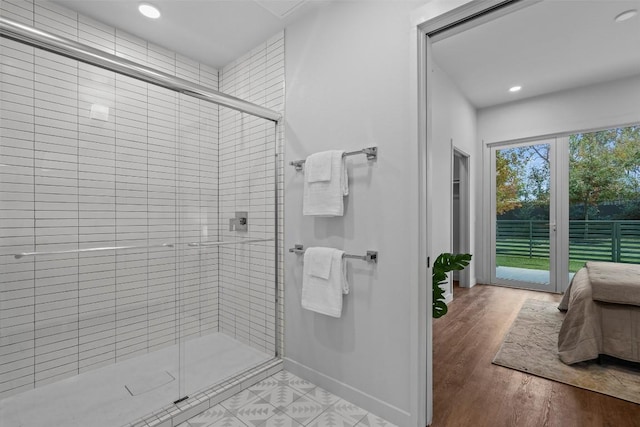 bathroom with hardwood / wood-style floors and an enclosed shower