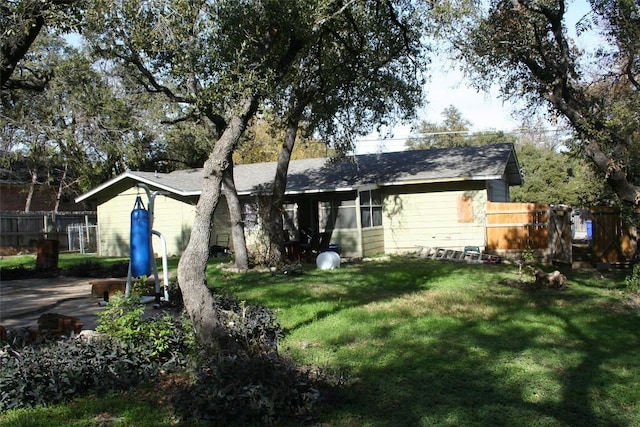 rear view of property with a lawn