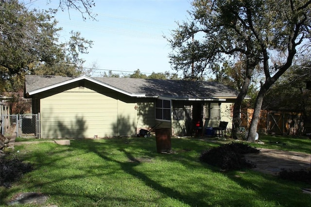 back of property featuring a lawn