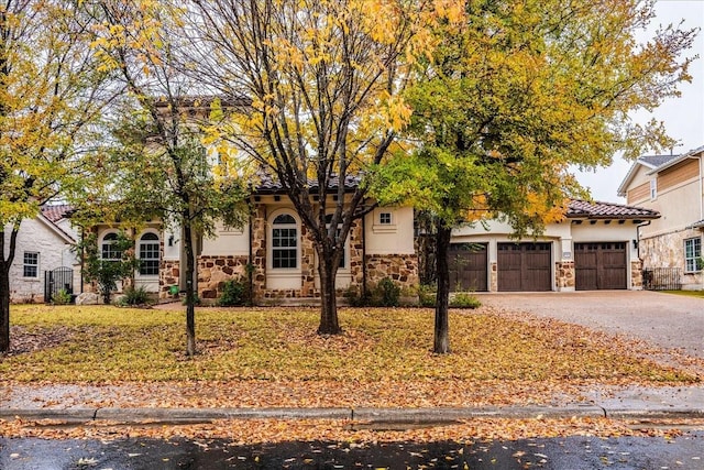 mediterranean / spanish-style home featuring a garage