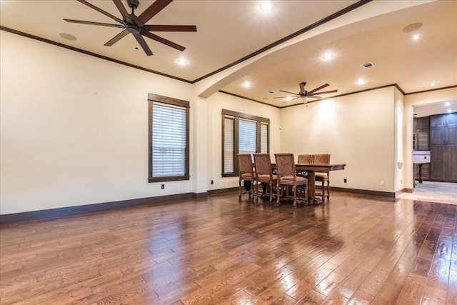 dining room featuring dark hardwood / wood-style flooring, ornamental molding, and ceiling fan