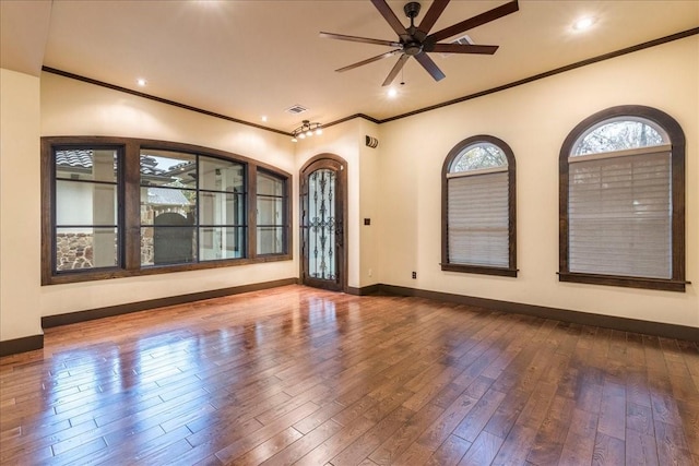 empty room with wood-type flooring, ornamental molding, and ceiling fan