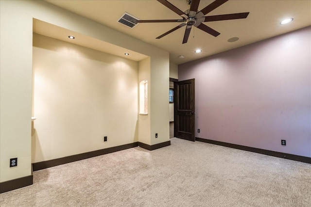 spare room featuring light carpet and ceiling fan