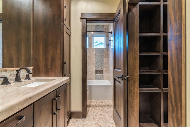 bathroom with vanity and a washtub