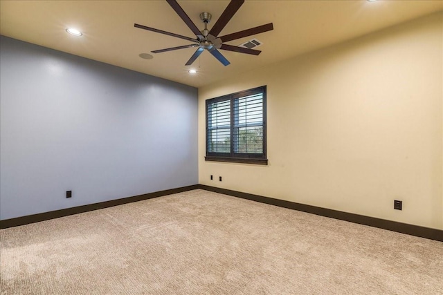 spare room featuring ceiling fan and light carpet