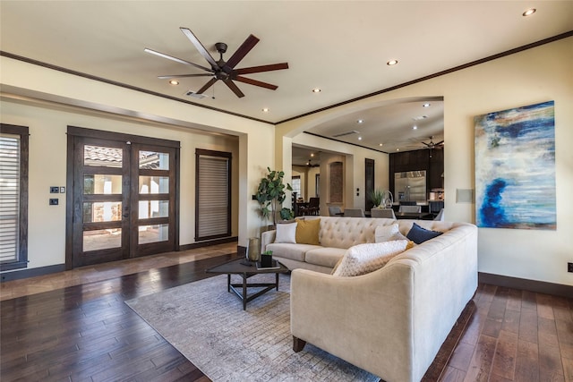 living room featuring dark hardwood / wood-style flooring, crown molding, french doors, and ceiling fan