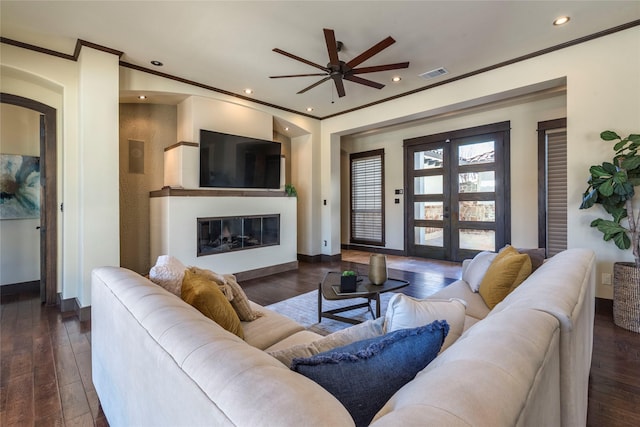 living room featuring ornamental molding, dark hardwood / wood-style floors, ceiling fan, and french doors