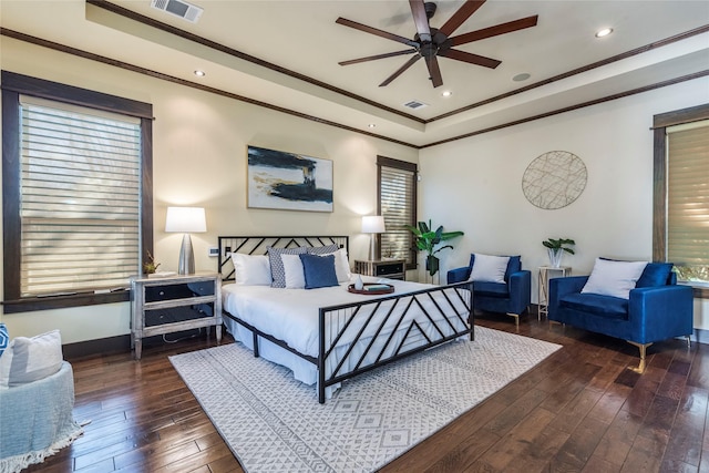 bedroom with ornamental molding, dark wood-type flooring, and ceiling fan