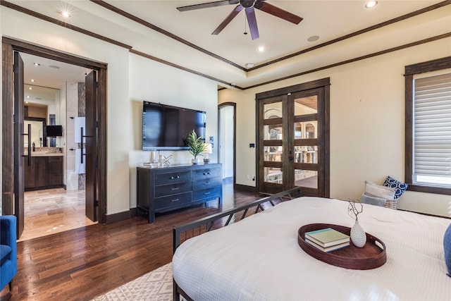 bedroom with ornamental molding, dark wood-type flooring, ensuite bathroom, and ceiling fan