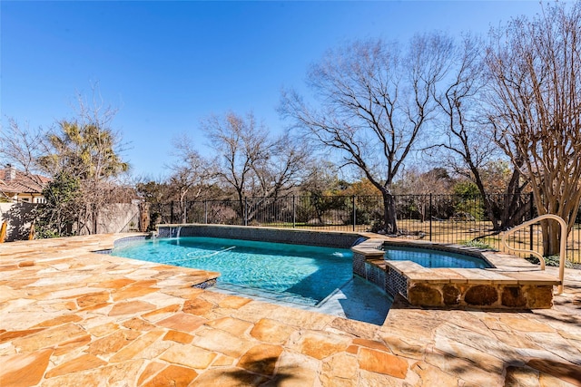 view of swimming pool with a patio, pool water feature, and an in ground hot tub