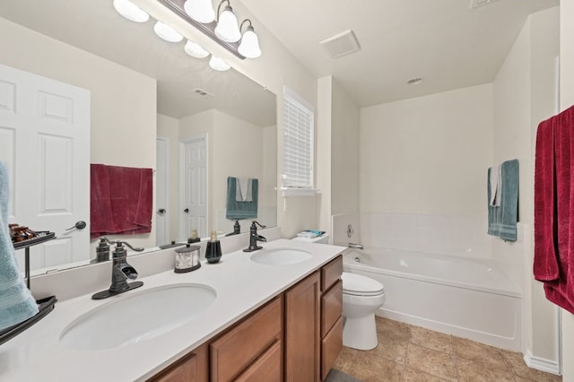 360 Gina Dr, Kyle, TX 78640 - bathroom featuring a garden tub, double vanity, and toilet