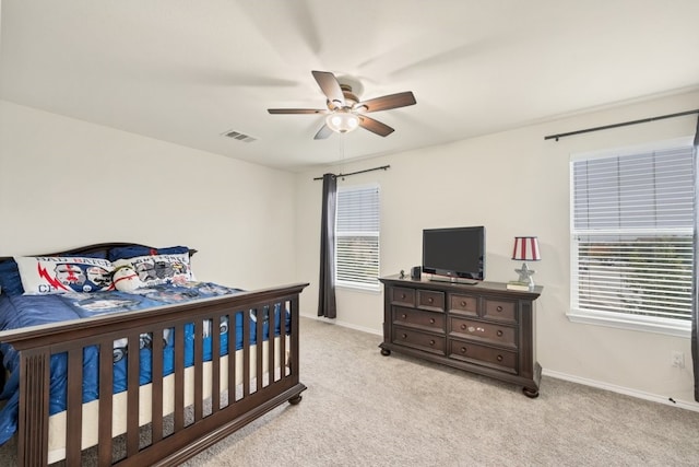 bedroom featuring ceiling fan and light carpet