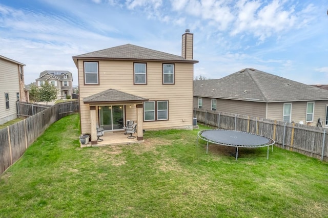 360 Gina Dr, Kyle, TX 78640 - rear view of property featuring a chimney, a trampoline, a patio, and a shingled roof