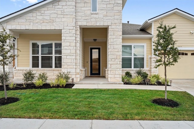 doorway to property featuring a lawn and a garage