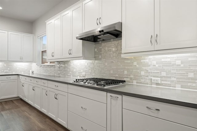 kitchen with decorative backsplash, white cabinets, dark wood-type flooring, and stainless steel gas stovetop