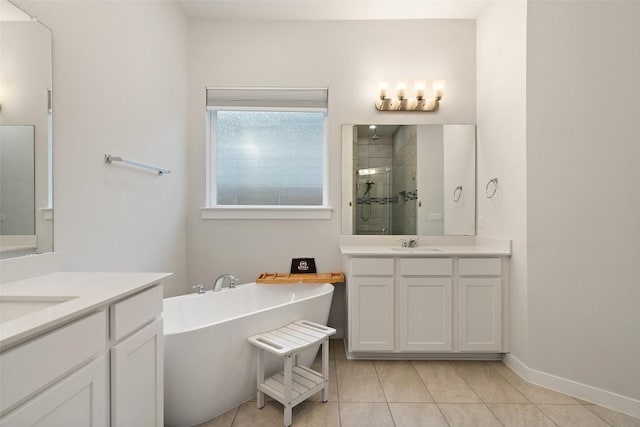 bathroom with tile patterned flooring, vanity, and shower with separate bathtub