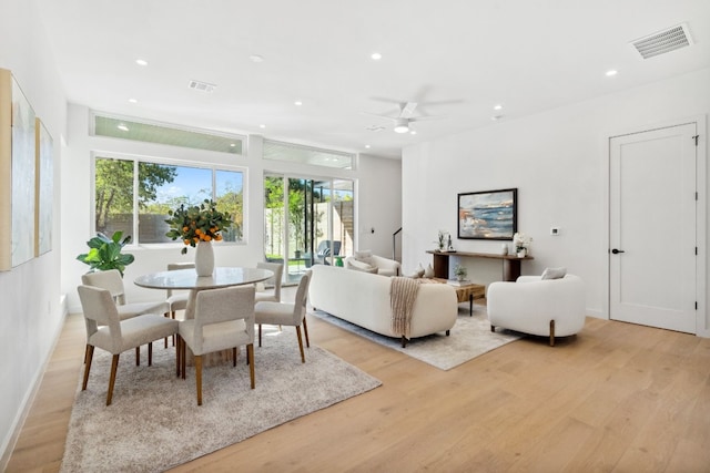 living room with light hardwood / wood-style floors and ceiling fan