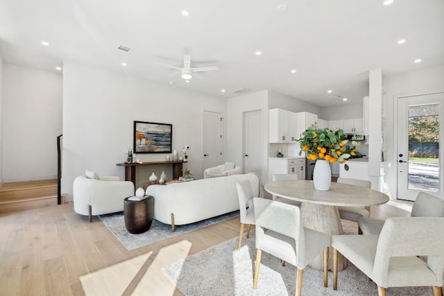 dining area with ceiling fan and light hardwood / wood-style flooring