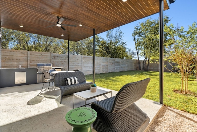 view of patio / terrace with grilling area, ceiling fan, and exterior kitchen