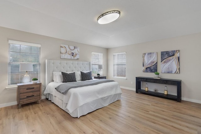 bedroom featuring multiple windows and light hardwood / wood-style floors