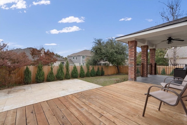 wooden deck with a yard and ceiling fan